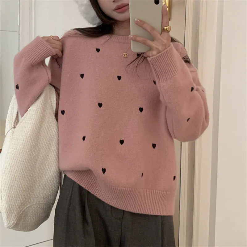 Women's loose beige acrylic pullover sweater with embroidered red love heart design on the chest.
