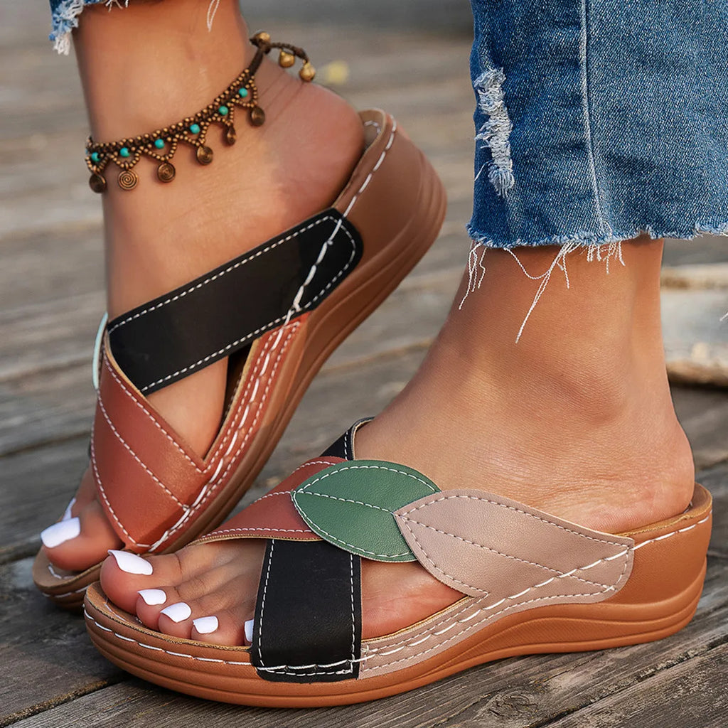 Women's black thick-soled slippers with a cross-strap and peep-toe fish-mouth design on a white background.