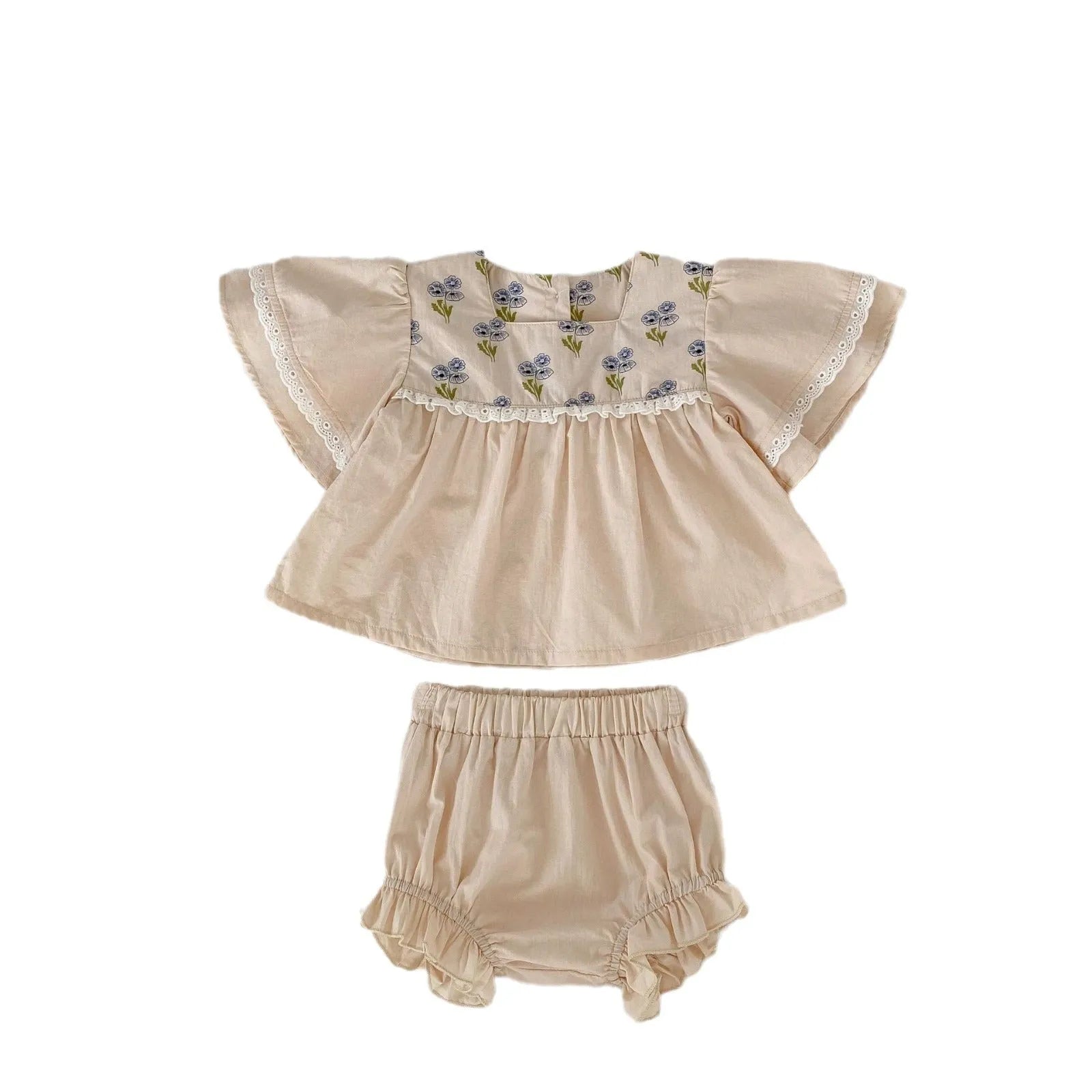 Apricot cotton two-piece suit with floral pattern, square collar top, and wooden horn buttons, next to matching bloomer pants.
