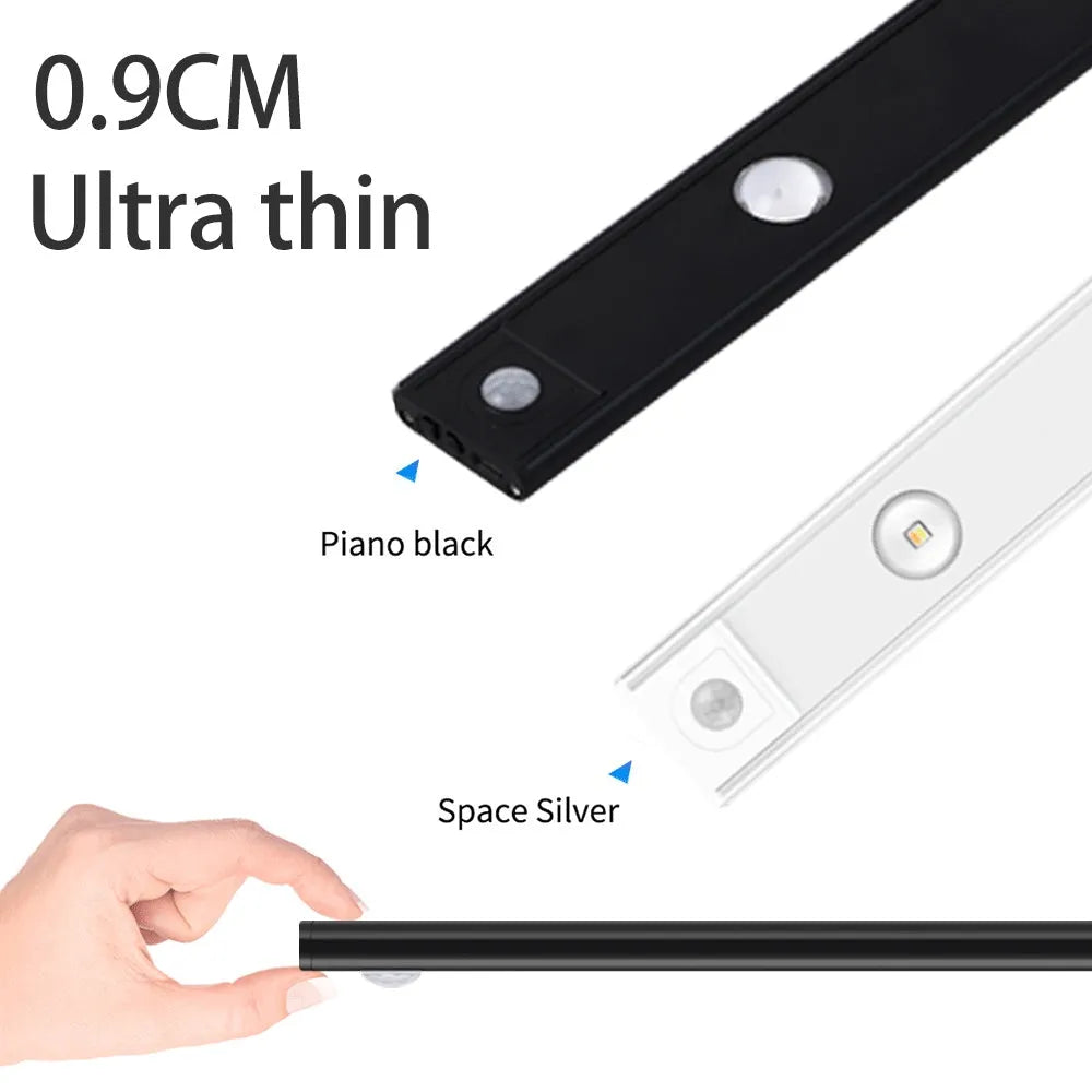 Silver ultra-thin wireless LED strip light with motion sensor attached to a kitchen cabinet door.