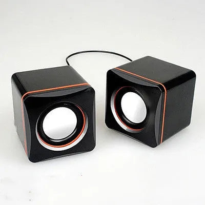 A small black square USB-powered 2.0 speaker for 700B computer systems.
