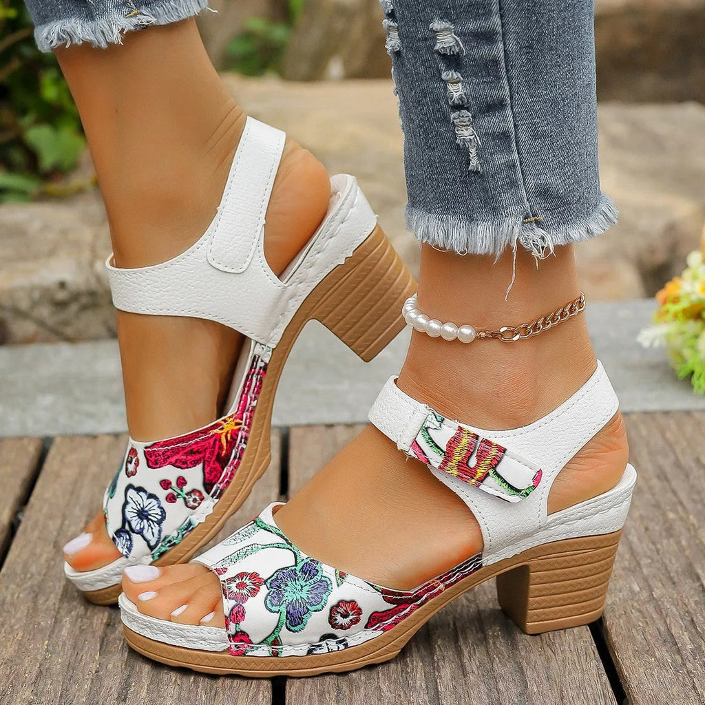 White women's high heel sandals with an adjustable Velcro strap buckle.