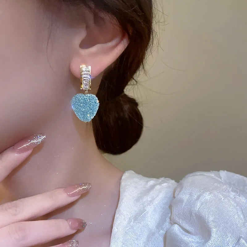 Peach heart-shaped stud earrings with candy gemstone accents in pink and blue colour variations