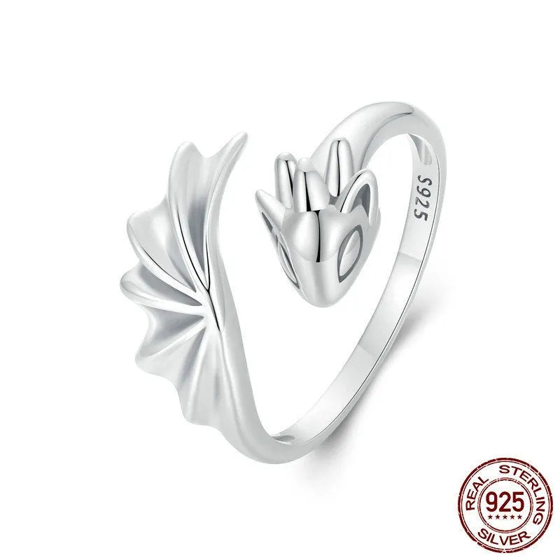 Unisex silver adjustable open ring with flying dragon wing motif on neutral background