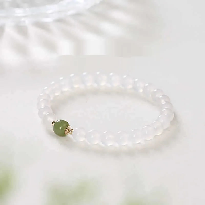 Handmade white agate bracelet with Hetian jade details and cinnabar inlays in 6mm and 8mm bead sizes