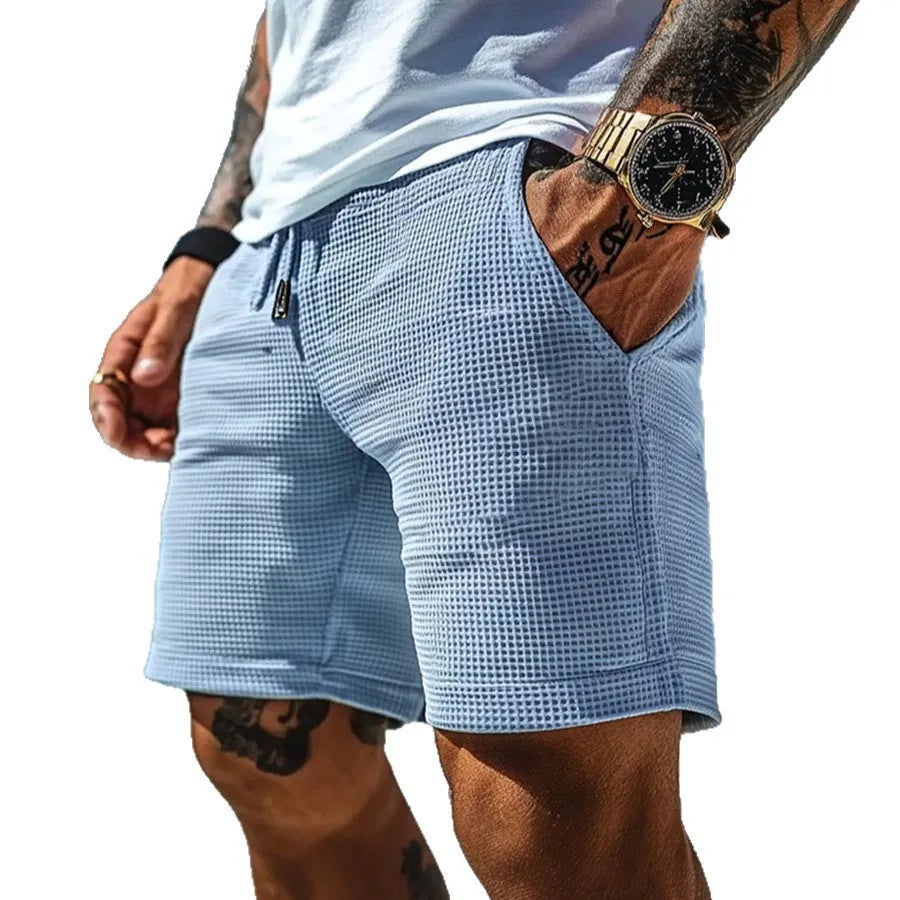 Men's light blue retro waffle knitted stretch surfing shorts with wide leg, front view