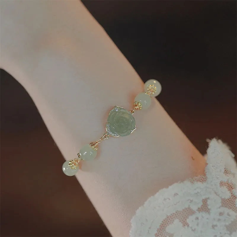 Women's jade bracelet with rose floral design and 14K gold gilding in Hetian Jade Rose colour.