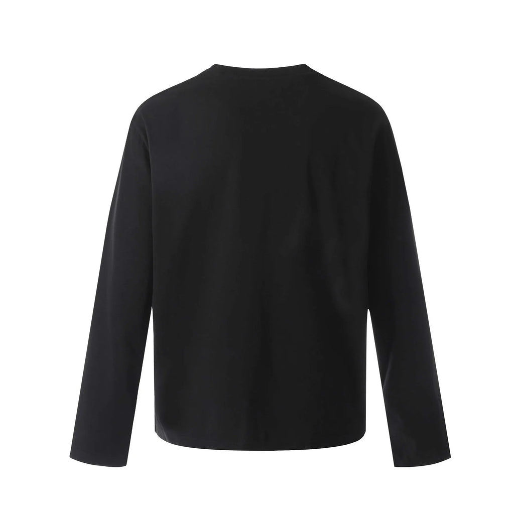 Man wearing a loose-fit black cotton pullover sweatshirt with long sleeves in a retro style.