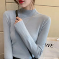 Slim fit knitted viscose top in apricot colour on a hanger, showing long sleeves and pullover design.