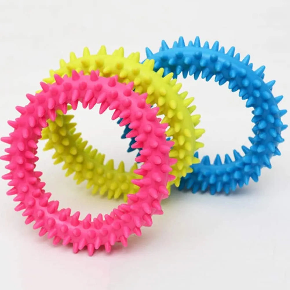 Blue TPR spiky ring dog chew toy for dental cleaning and bite training on a white background.