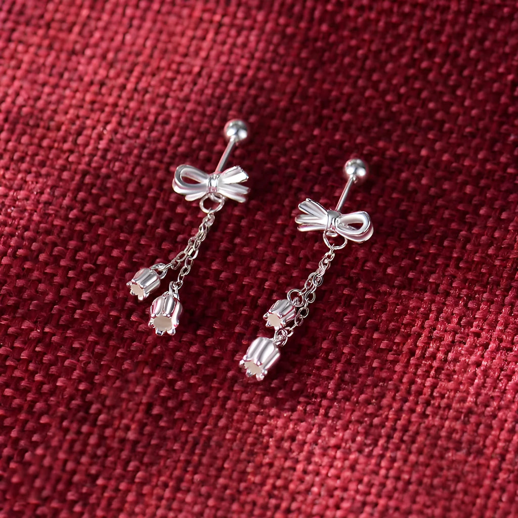 Silver bow ear studs with sweet tassel details and Korean style design for women