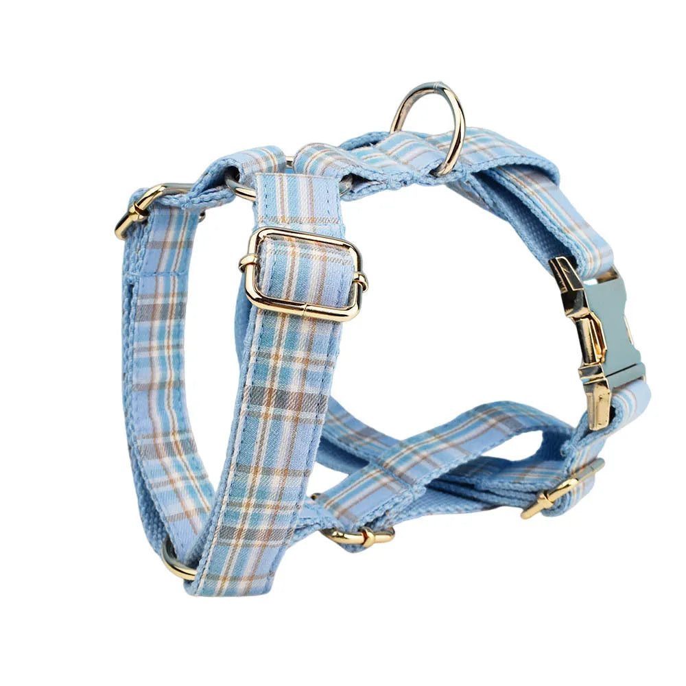 Sky blue grid forest pattern dog collar, leash, bow, and vest four-piece set on white background