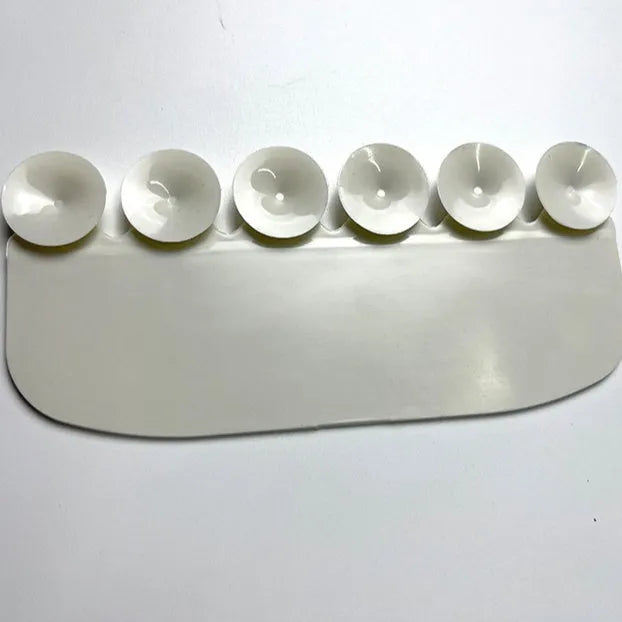 White PVC urine blocking board for children's toilet training placed on standard toilet seat