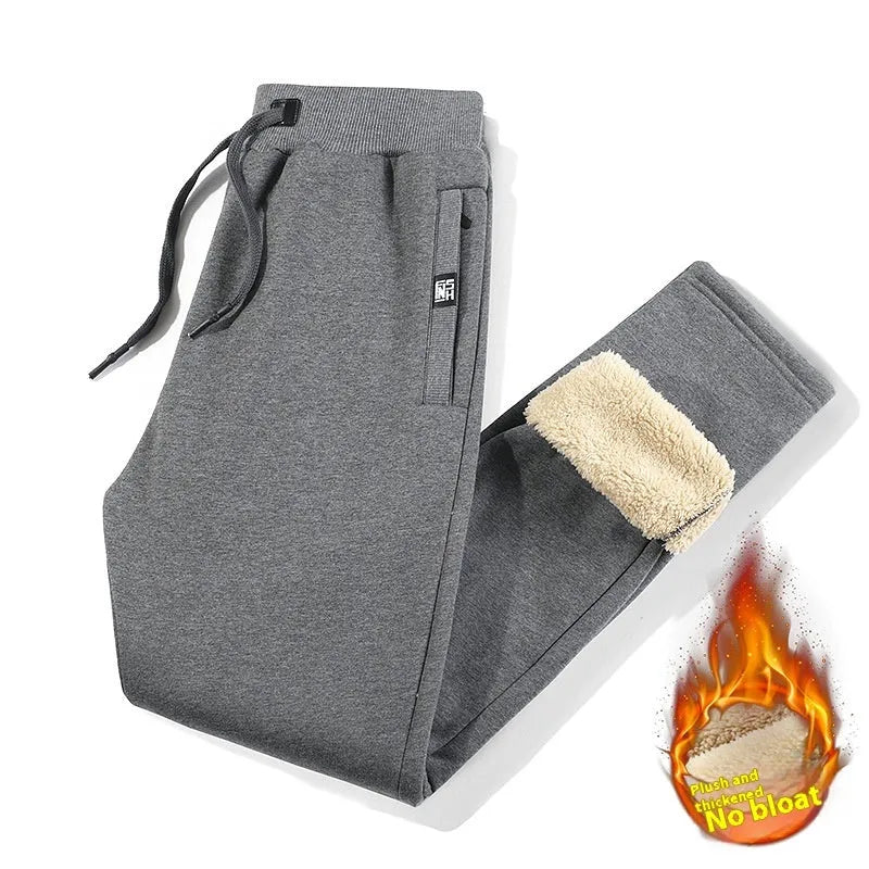 Man wearing grey fleece-lined cotton track pants with an elastic mid waist.