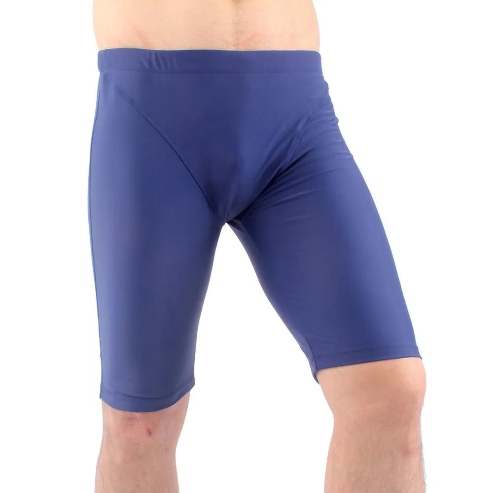Men's green loose-fit five-point swimming trunks made from quick-drying nylon fabric.