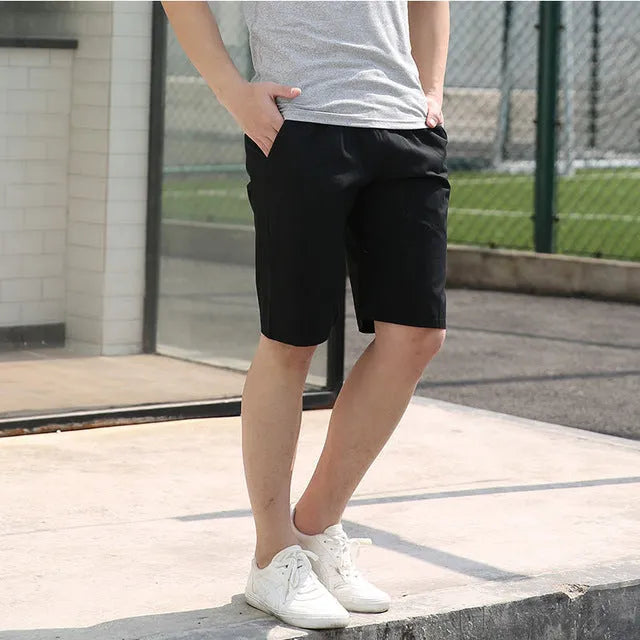 Men's cotton summer casual shorts in black, showing trouser-length cut and regular fit