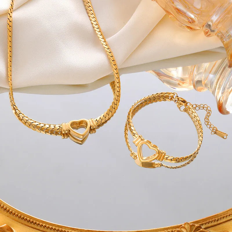 Gold titanium steel personalised love chain necklace and bracelet set with Cuban links and heart shape on white background