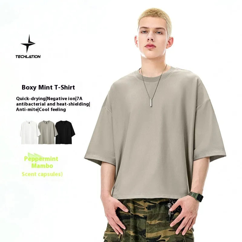 Men's sand grey loose fit short sleeve cotton polyester t-shirt laid flat.