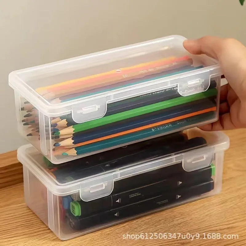 Transparent pencil storage box showing organised stationery including pencils and art supplies