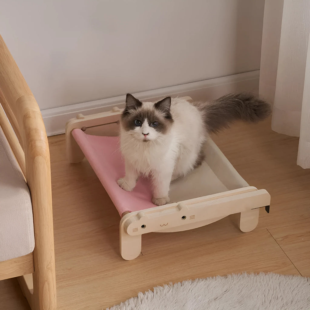 Solid wood cat bed with removable cushion in grey-toned seasonal pattern colours