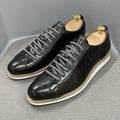 Men's low-top handmade shoes with embossed pattern detail on the upper and front lace closure.