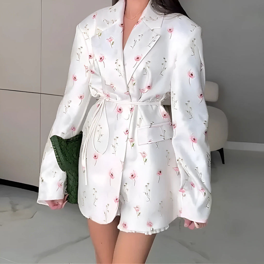 White suit jacket with a lace-up collar and a fitted waist on a model.
