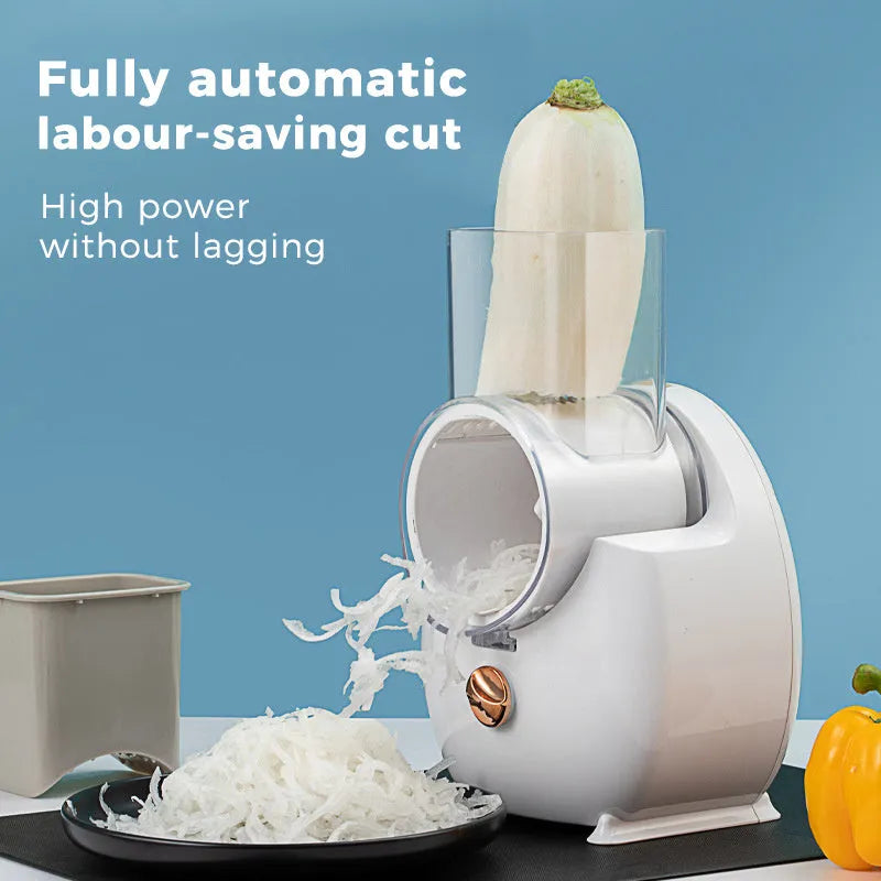 White electric vegetable slicer with suction base and interchangeable blades on kitchen counter