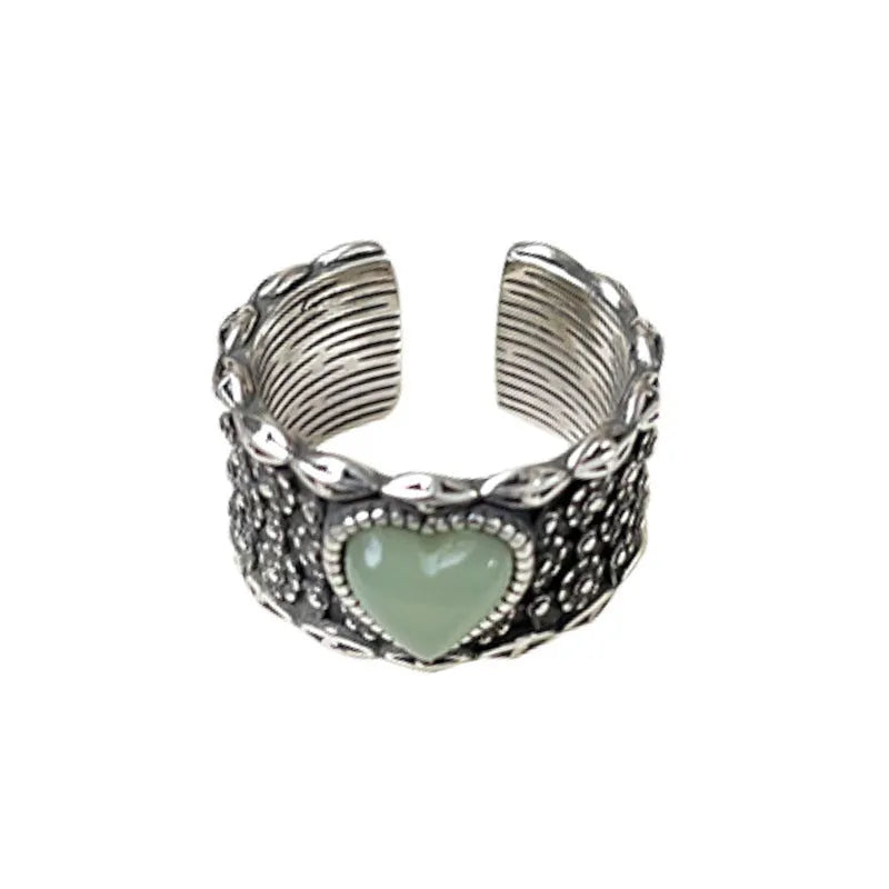 Retro-style adjustable silver heart ring shown in white and green colour options.