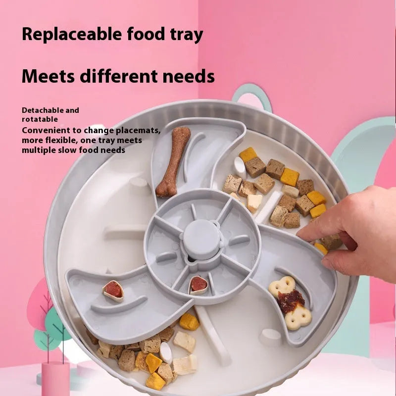 Rotating plastic pet feeding game board with blue silicone licking mat and a separate white bowl on a wooden table.