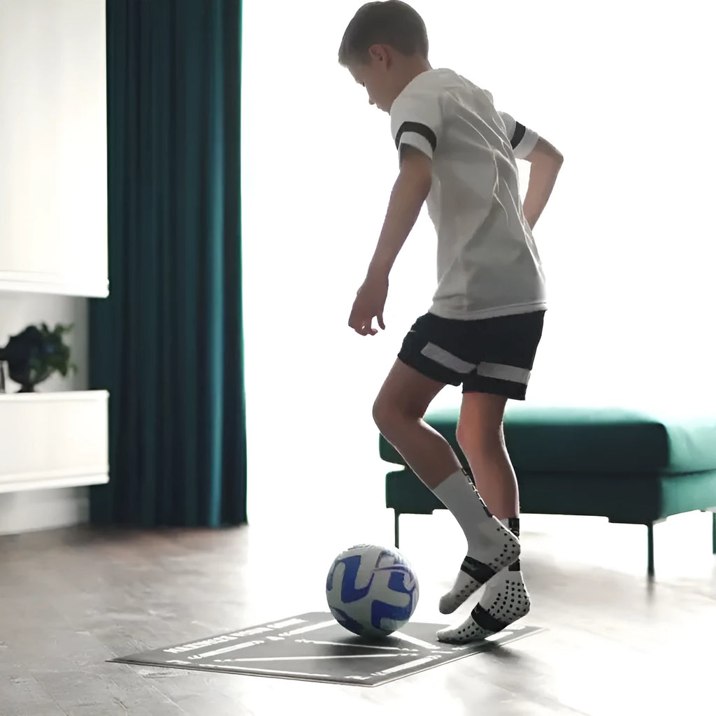 Black non-slip football training mat measuring 60cm by 90cm on a flat surface.
