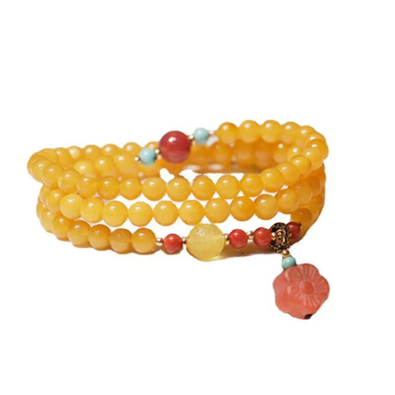 Yellow amber bracelet with 5mm round beads and animal zodiac design on wrist