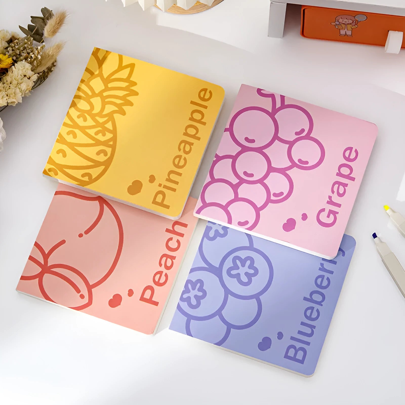 Square 14.5cm notebook with fruit-embossed cover showing pineapple, blueberry, grape or peach designs