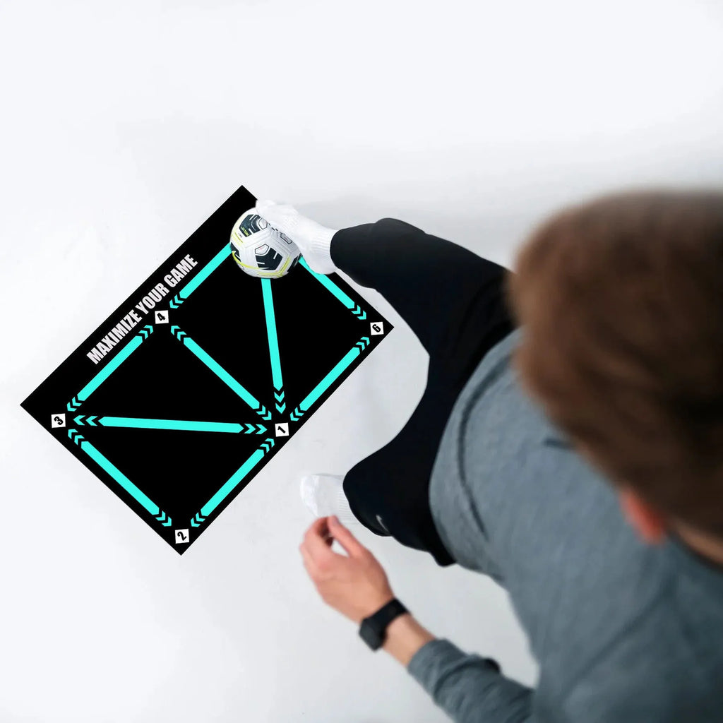 Black non-slip football training mat measuring 60cm by 90cm on a flat surface.