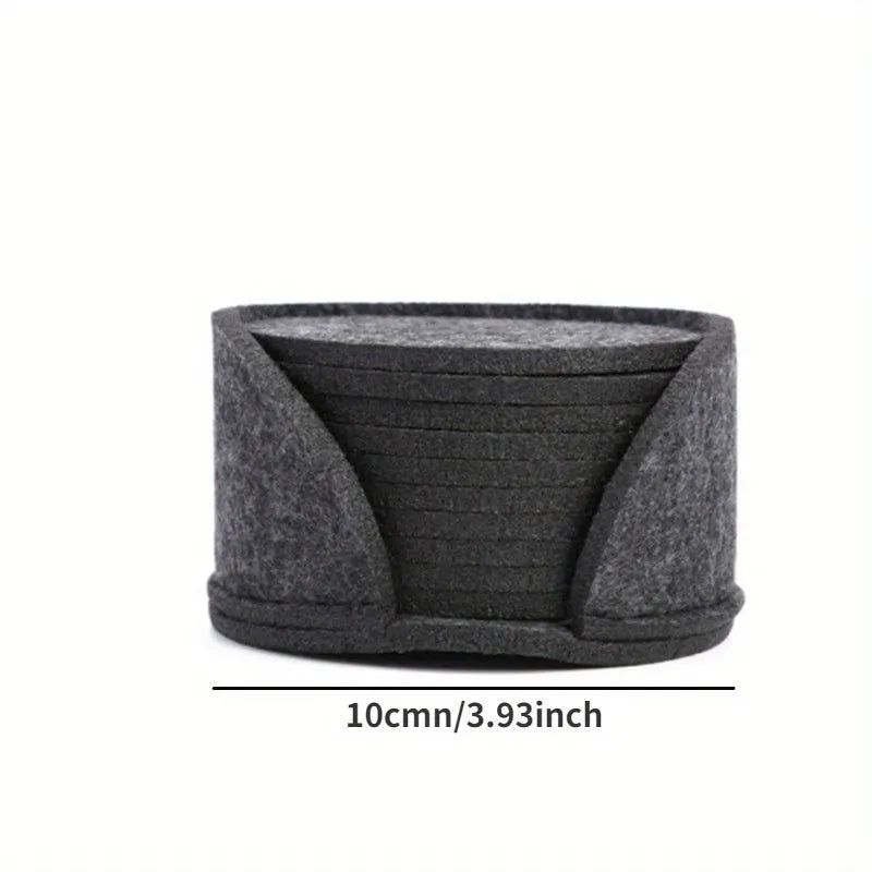 10 round felt coasters in black, brown, dark gray, and light gray arranged on a dining table