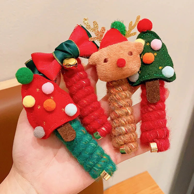 Children Christmas hair ties with red bell, green tree, khaki elk, and red tree designs on a light background