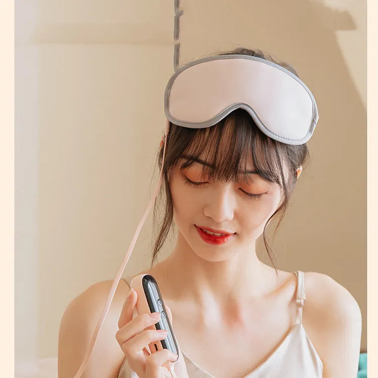 Pink and green suede portable eye spa mask with USB charging for steam heat and vibration massage.
