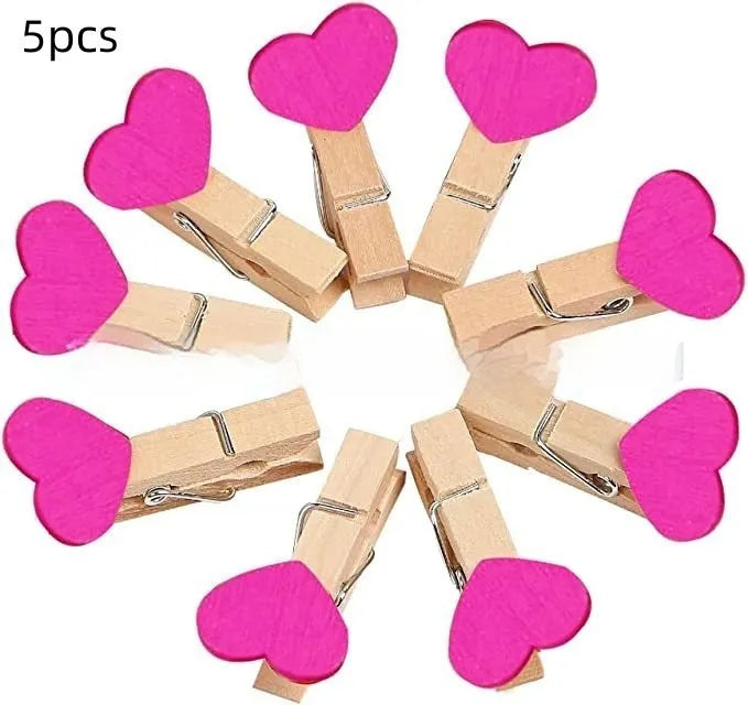 Set of five handmade wooden heart-shaped decorative clips in assorted colours.