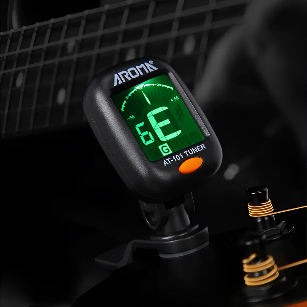 Automatic clip-on multi-function guitar tuner with LCD display attached to an acoustic guitar headstock