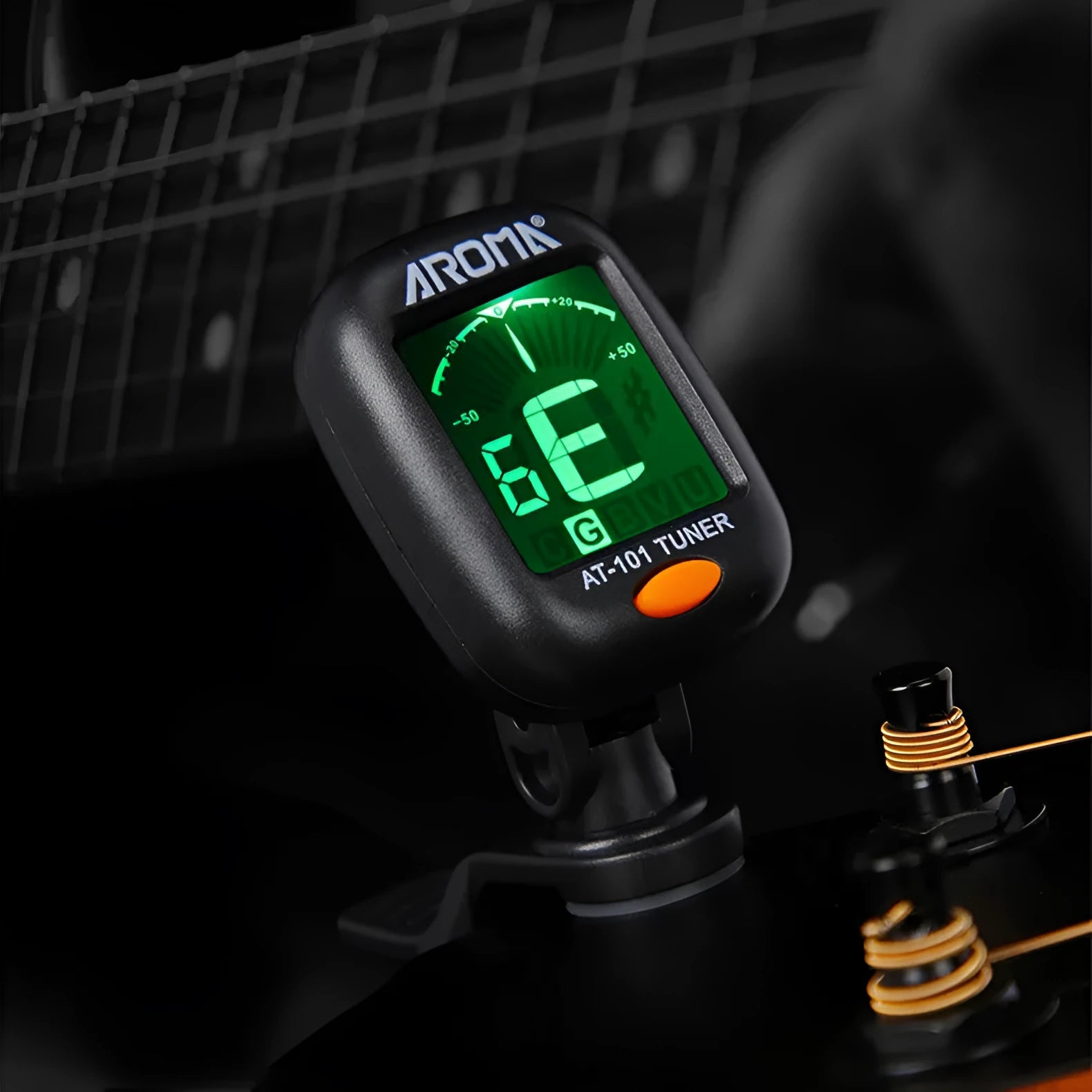 Automatic clip-on multi-function guitar tuner with LCD display attached to an acoustic guitar headstock