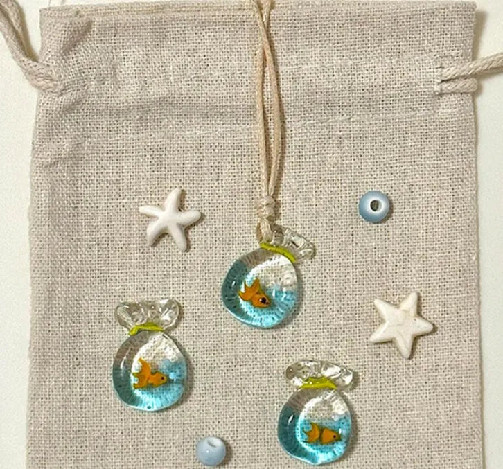 Women's necklace with a colourful skirt joker pendant on a long, braided cotton and linen chain.