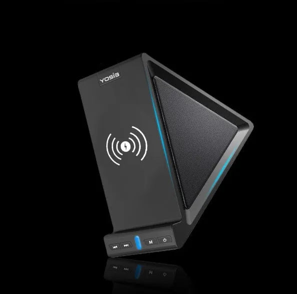 Black multifunctional Bluetooth speaker with integrated phone stand and wireless charging pad, showing size relative to a mobile phone.