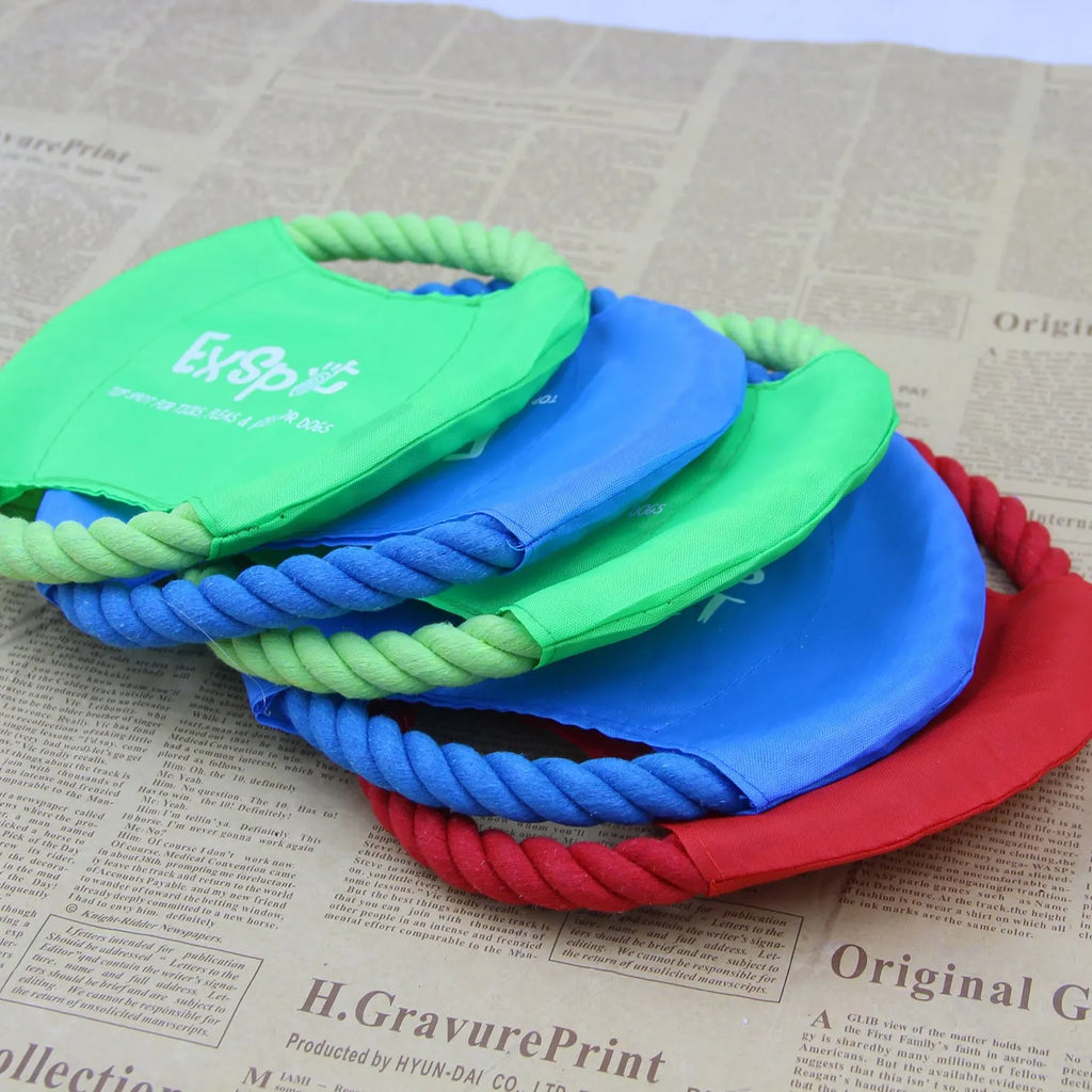 Canvas and rope dog flying disc toy with rain silk surface, 19cm diameter, on grass