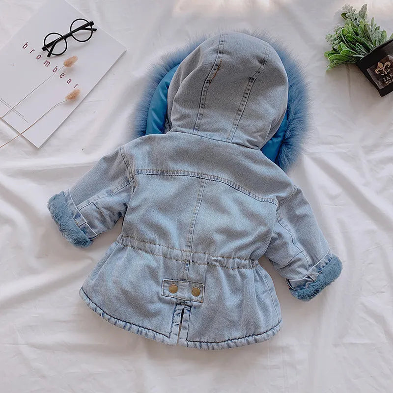 Blue denim coat for a young girl with a fleece lining and a non-removable hood.
