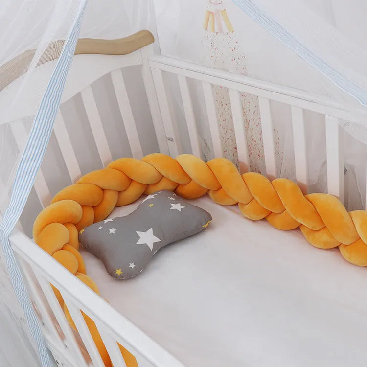 Long, flexible baby crib bumper pillow in spandex velvet, shown fitted around a white cot for safety protection.