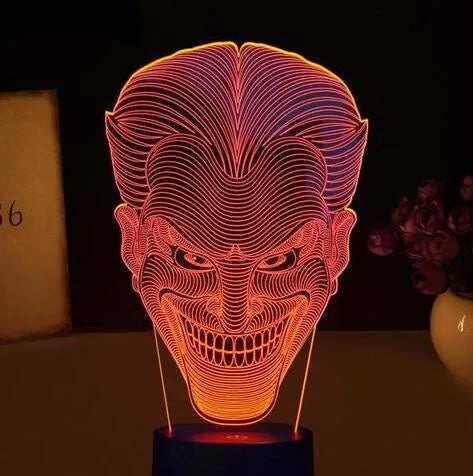 USB-powered 3D LED desk lamp showing multiple colour modes on an acrylic panel with a remote control.