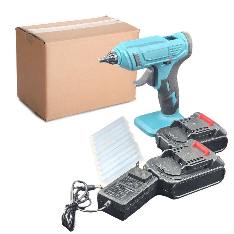Rechargeable hot melt glue gun with lithium batteries and glue sticks on work surface