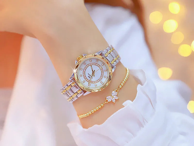 Women's quartz watch with 32mm round dial, alloy case, and mineral glass in a choice of gold or silver finishes