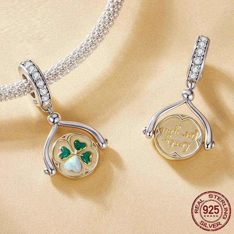 925 silver rotating card pendant with four-leaf clover pattern and wings motif on white background