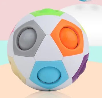 Colourful rainbow ball puzzle toy with visible holes, 5.5 cm in diameter.