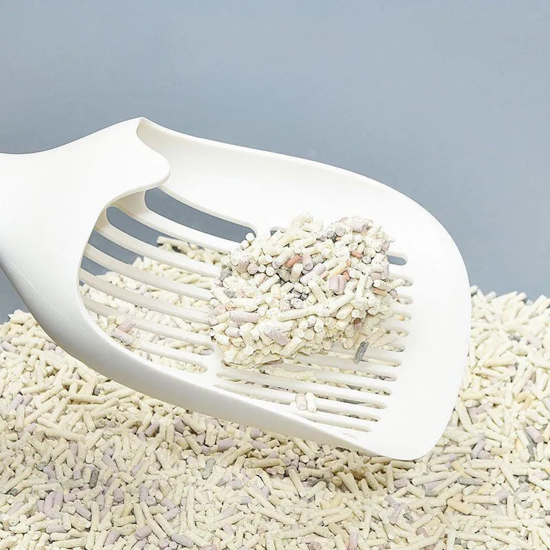 Large white plastic cat litter shovel for scooping clumping tofu cat litter.